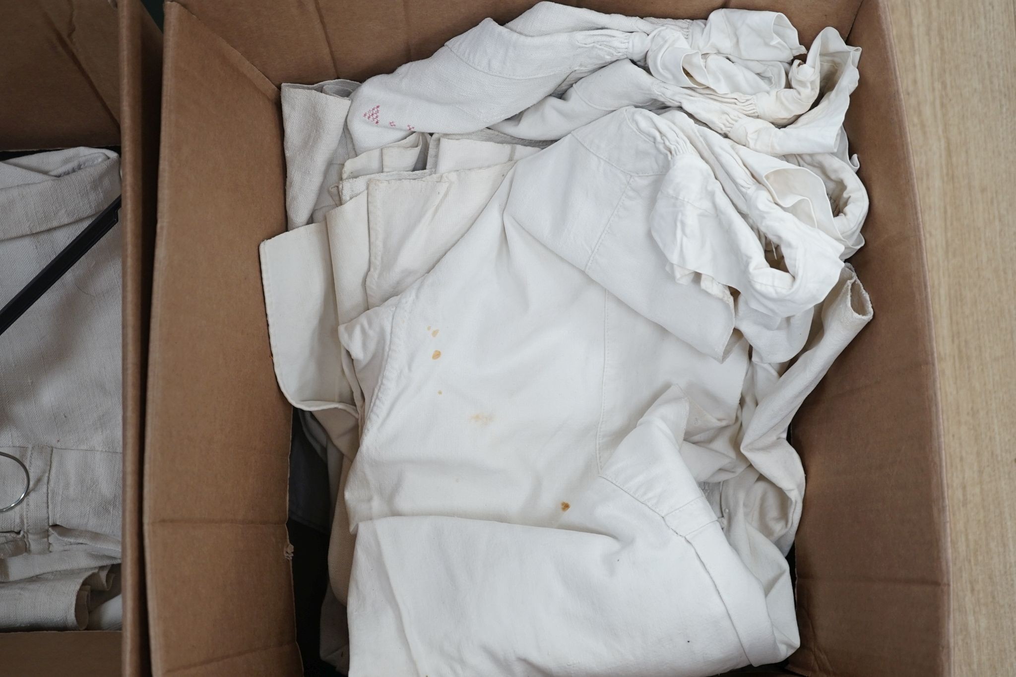Eleven French coarse linen provincial farmworker's smocks.